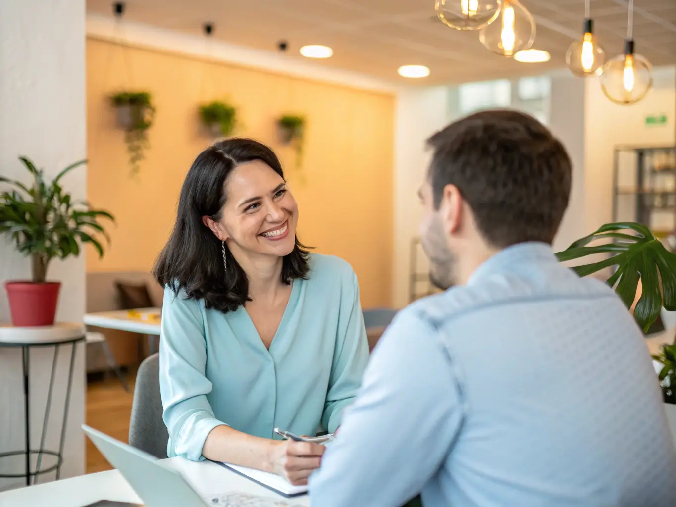 A coach is conducting a one-on-one session with a client, focusing on improving their emotional intelligence and interpersonal skills in a quiet, professional office.